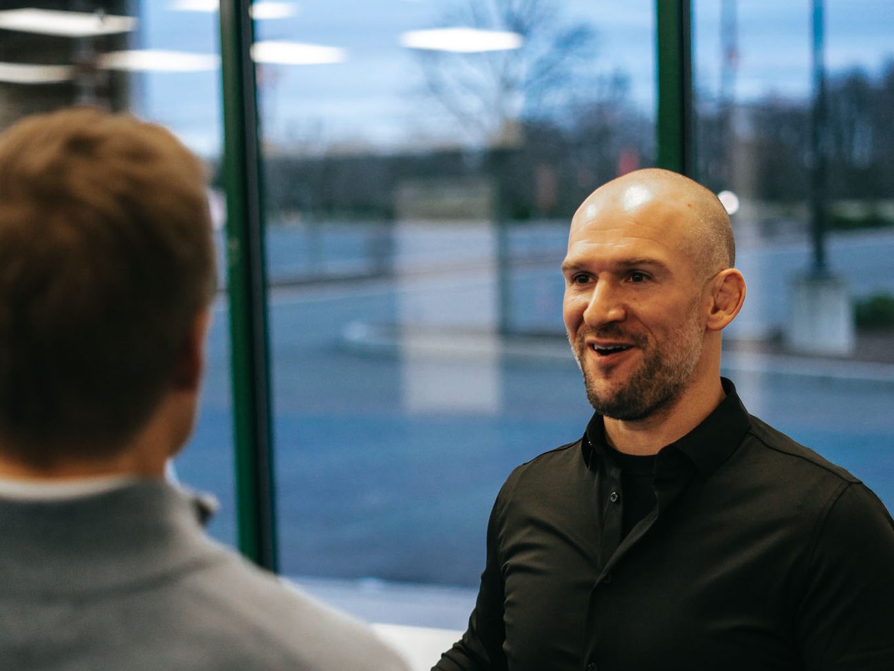 Chris Matakas smiling as he talks with a client