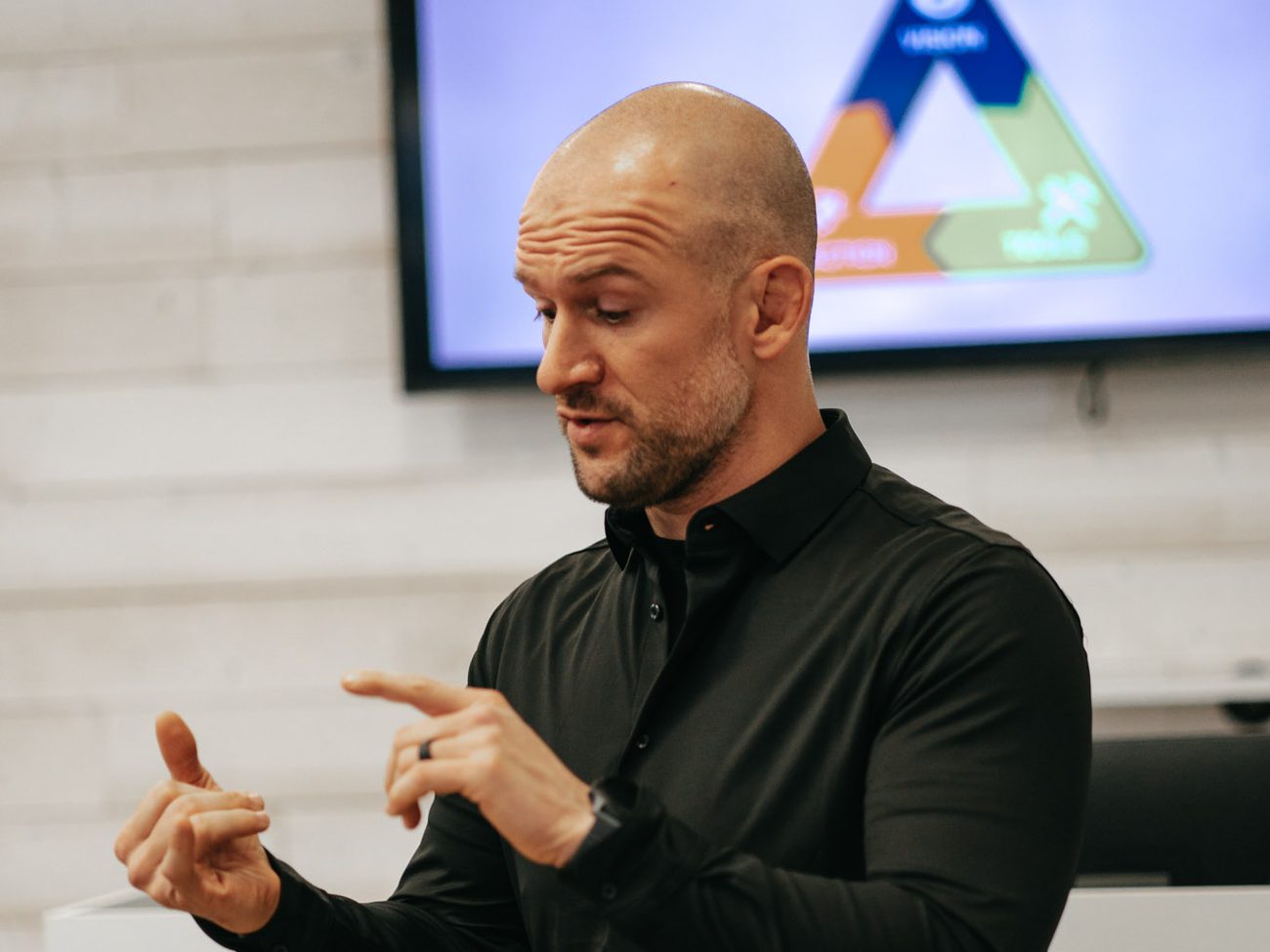 Chris Matakas speaking in front of a slide of the Transformation Triangle